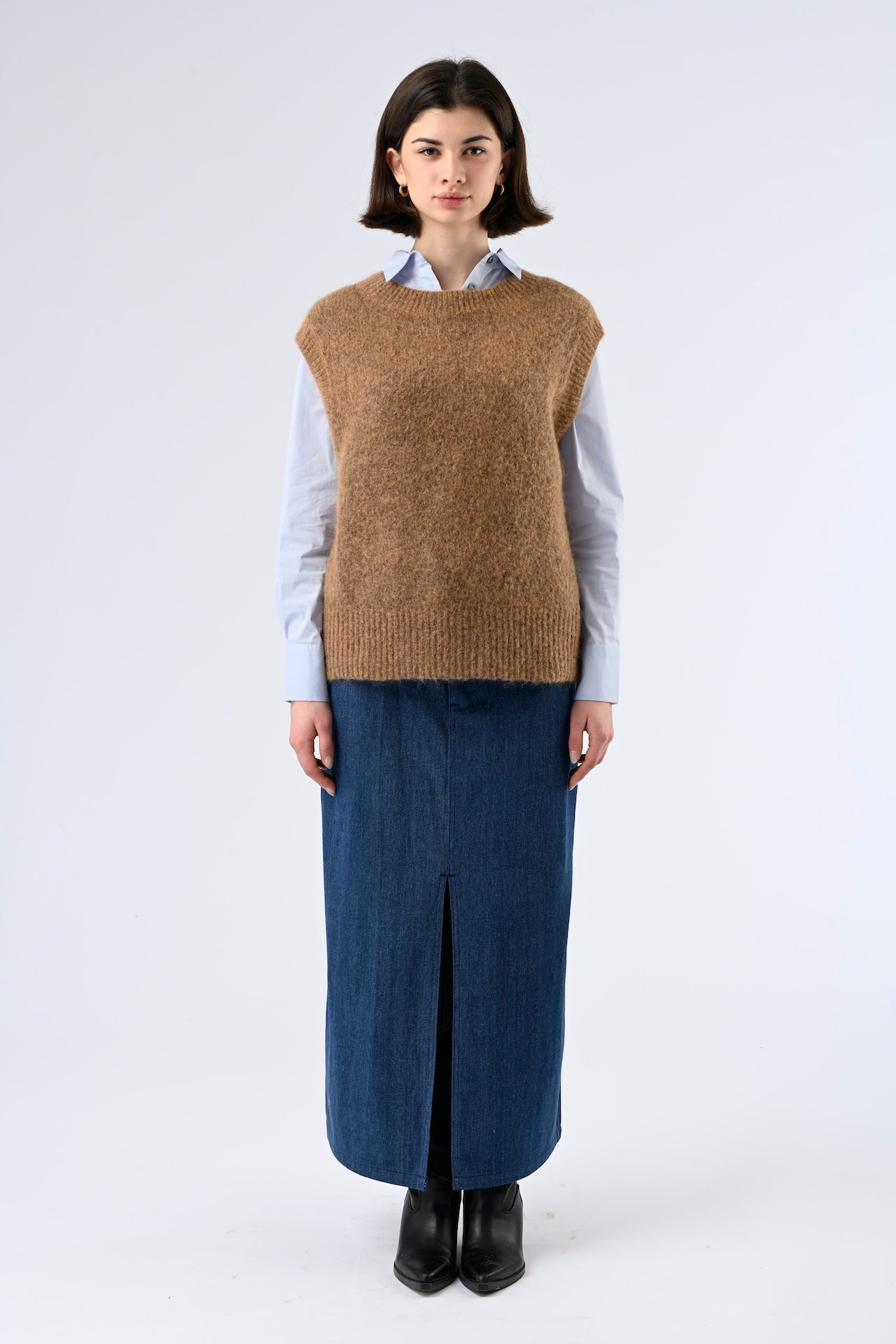 Minimalist hazelnut brown sweater vest styled over blouse