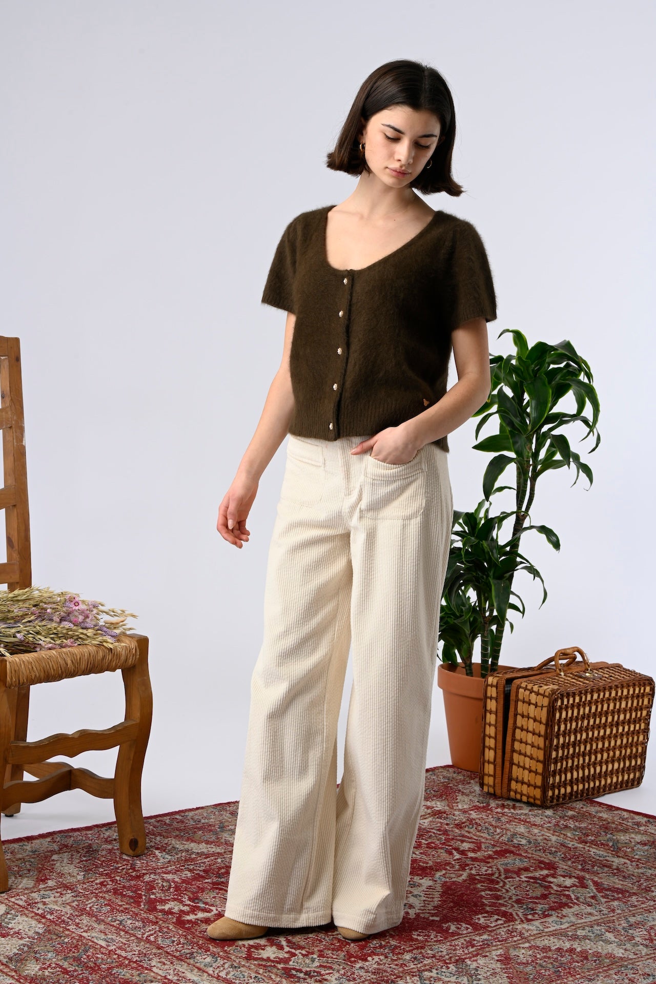 Woman wearing flattering high-rise ecru trousers for everyday styling