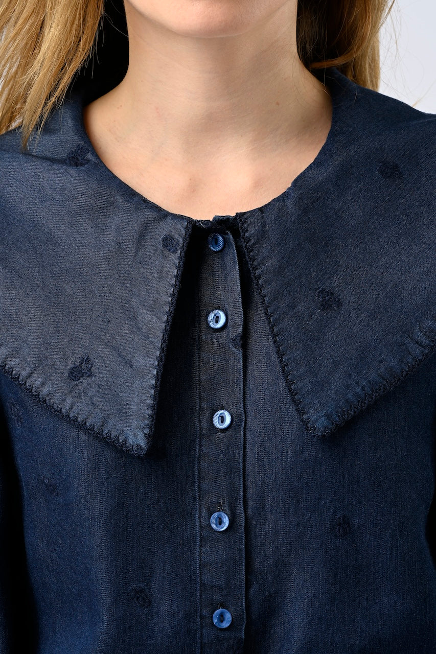Close up of dark chambray shirt with statement collar and embroidery