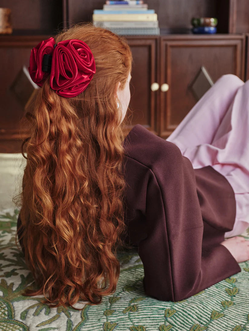 Beck Sondergaard Red flower-shaped hair clip on a white background show n in model's hair