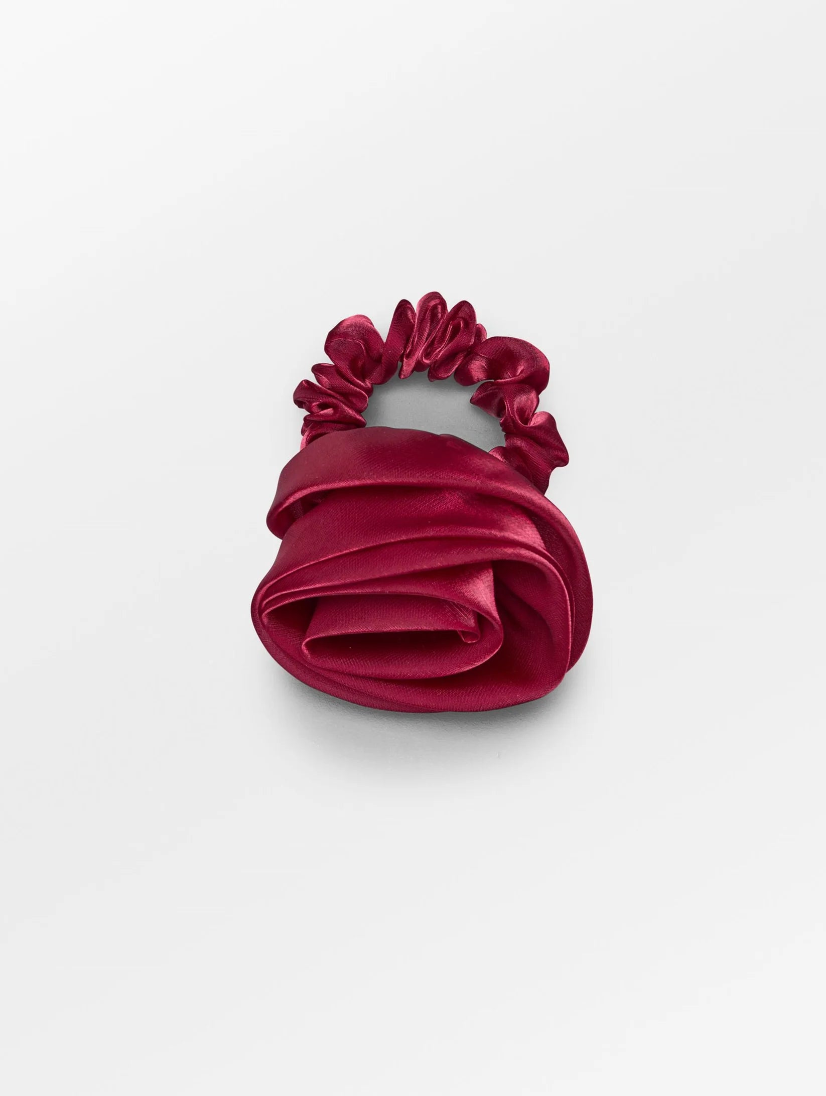 Beck Sondergaard Red satin rose shaped hair scrunchie on a white background