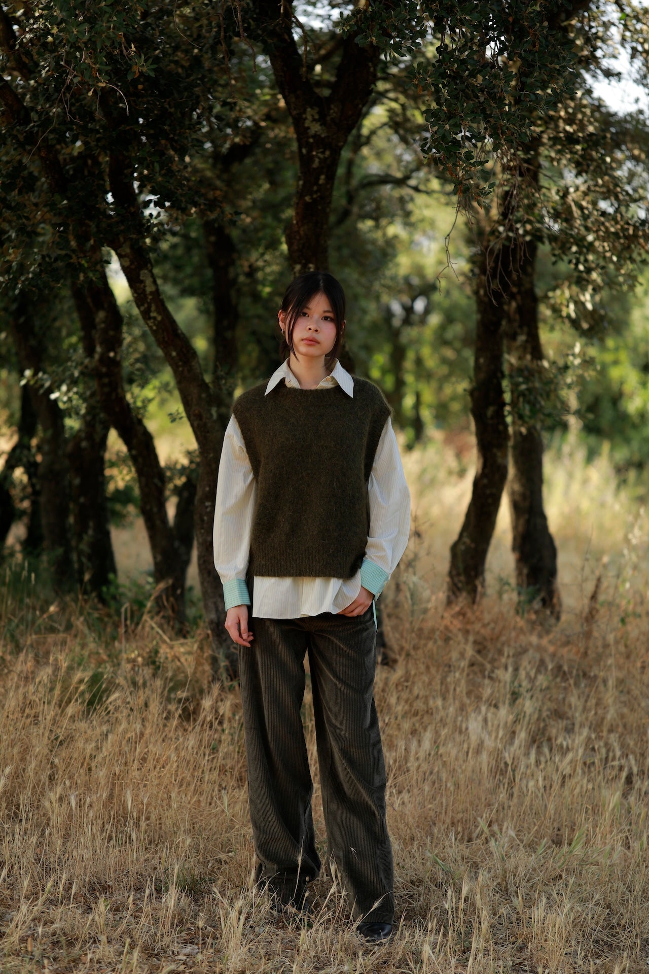 woman in field wearing Orfeo khaki trousers with Orfeo Koline Vest 
