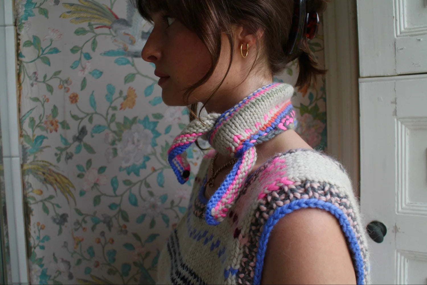 Model wearing Soft wool knit scarf tied at the neck