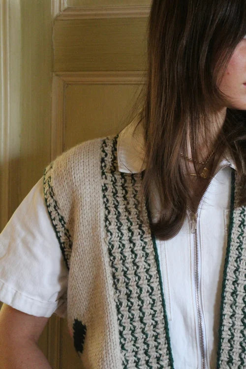 Handcrafted sleeveless knit cardigan with bold stripe pattern
