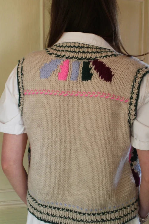 Beige hand knitted vest with colourful patterns on the back