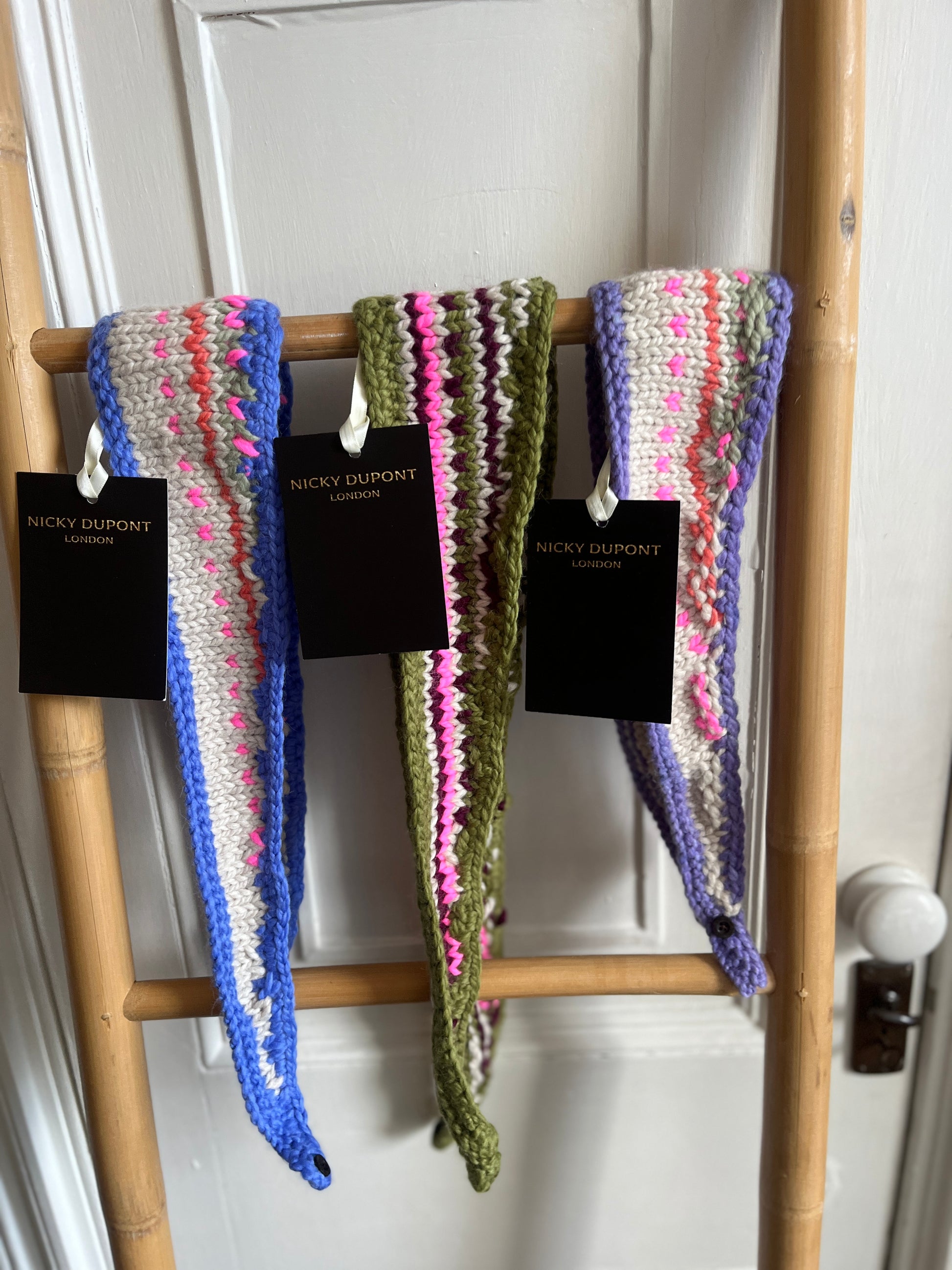 selection of Women’s handcrafted necktie scarves hanging on ladder