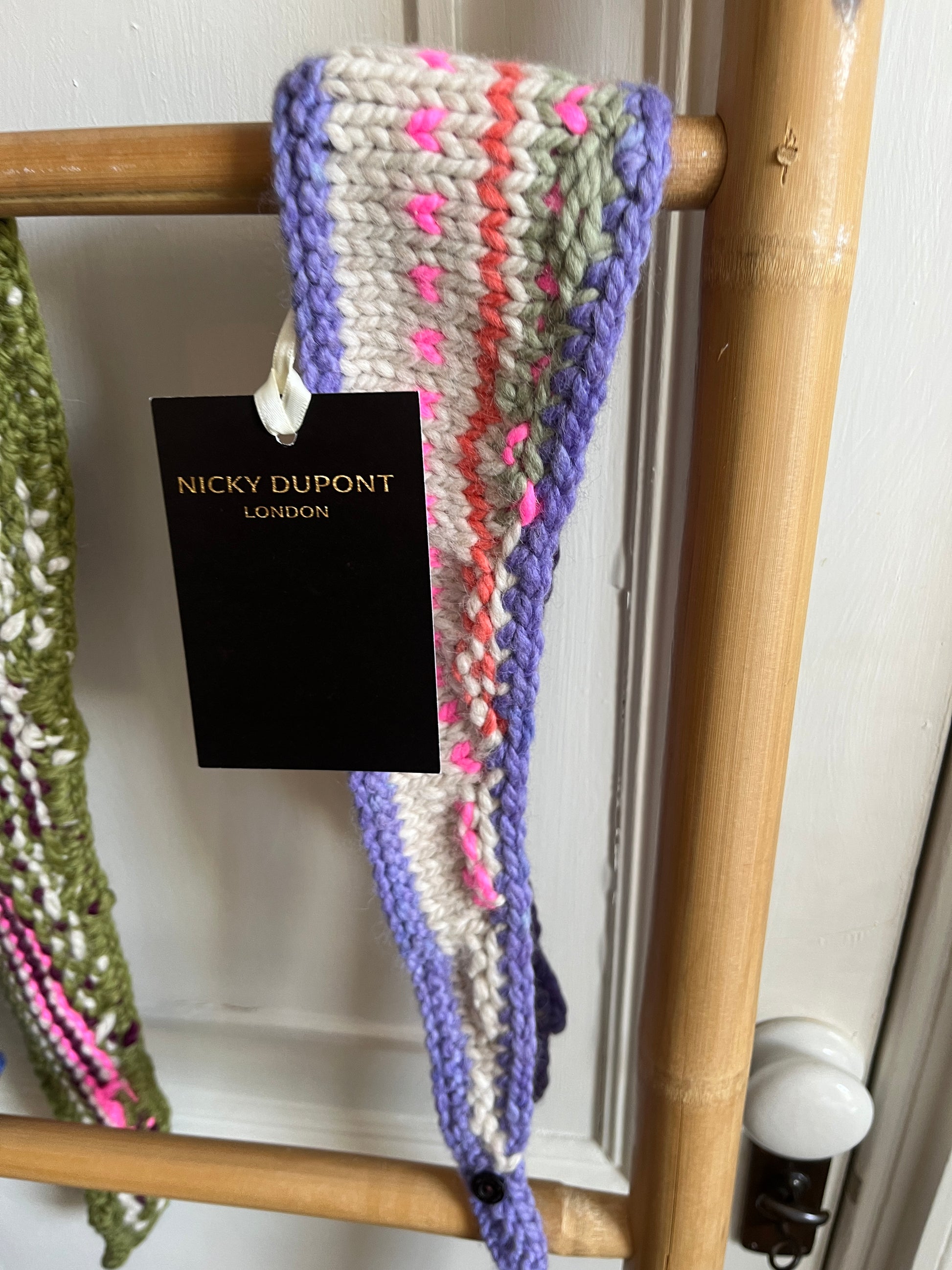 Women’s handcrafted necktie scarf in puple hanging on ladder