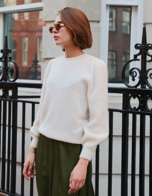 Puff sleeve jumper in cream - great transition piece worn by model in sunglasses and green skirt


