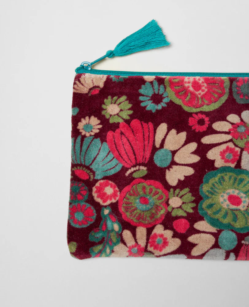Medium velvet pouch with cotton lining and tassel against white background 

