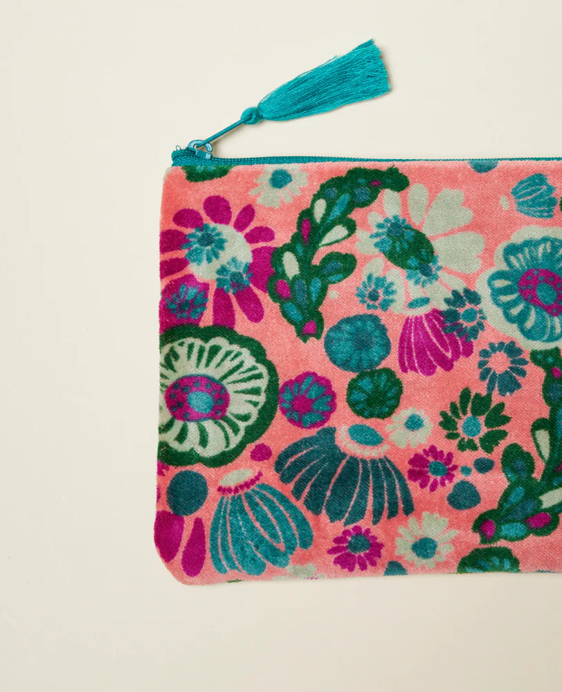 Floral patterned velvet pouch with a turquoise zip and tassel  close up