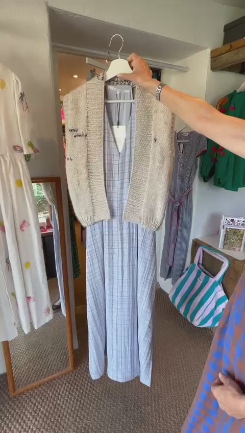 hand knitted Nicky Dupont sweater vest - off white with blue details shown over a dress - front and back 